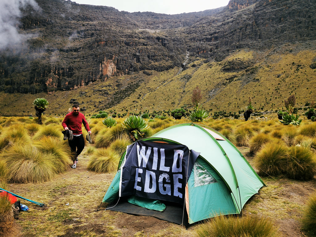 campsite with the wild edge expedition flag
